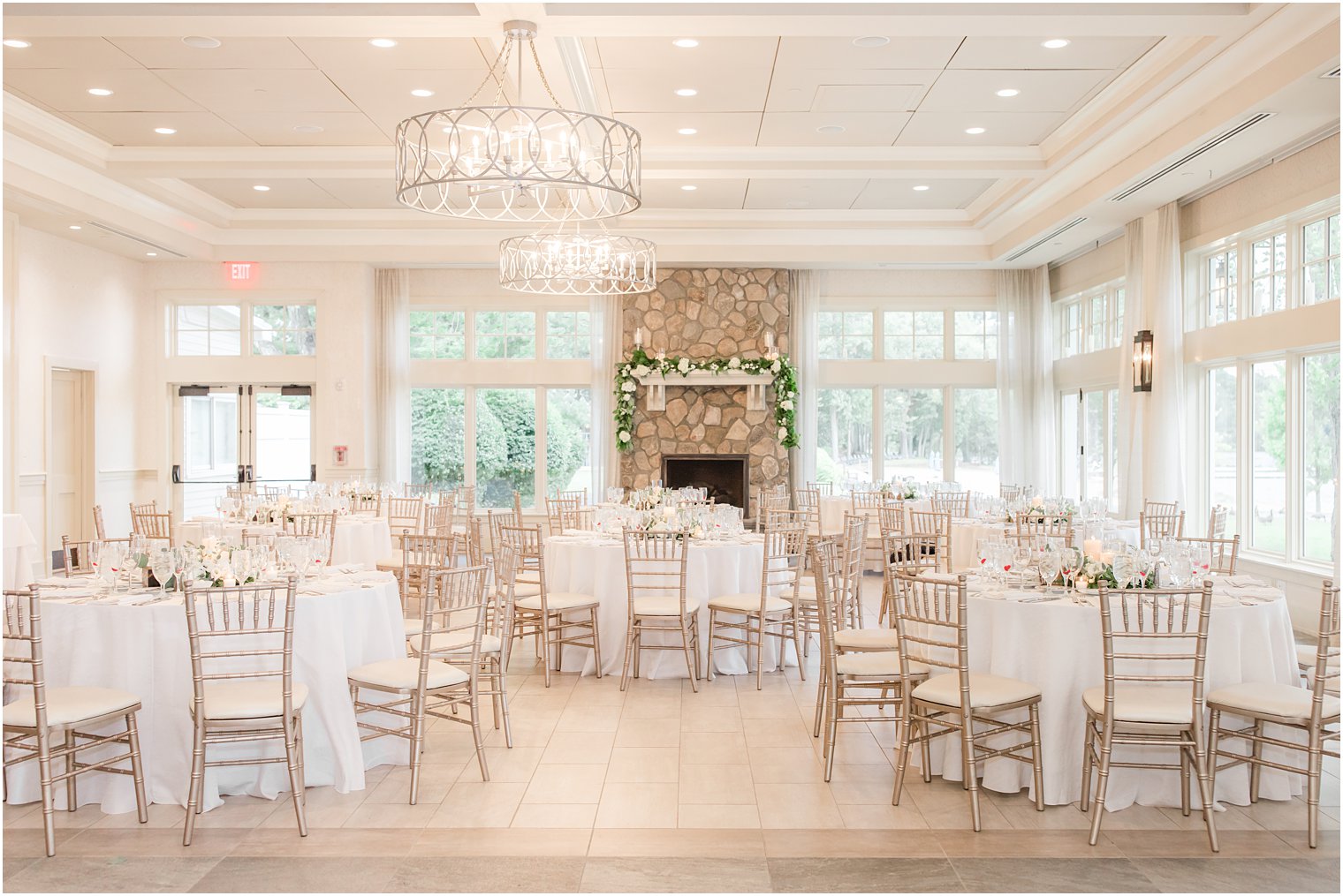 indoor wedding reception with gold chivari chairs at Indian Trail Club
