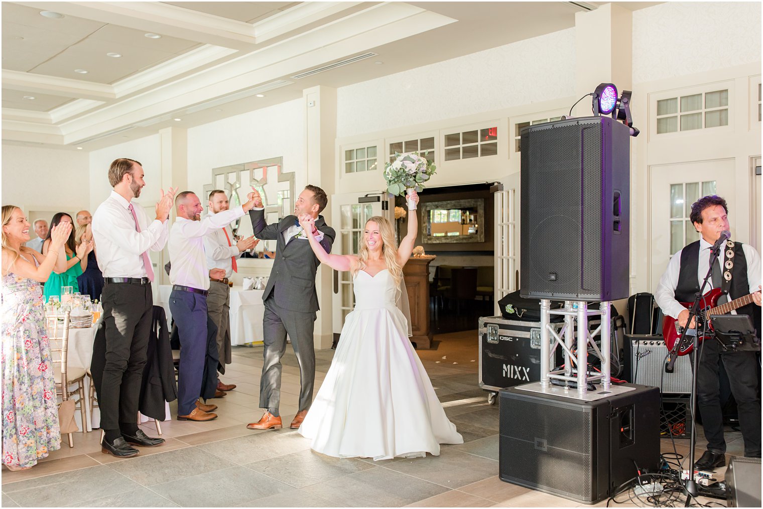 bride and groom cheer during New Jersey wedding reception