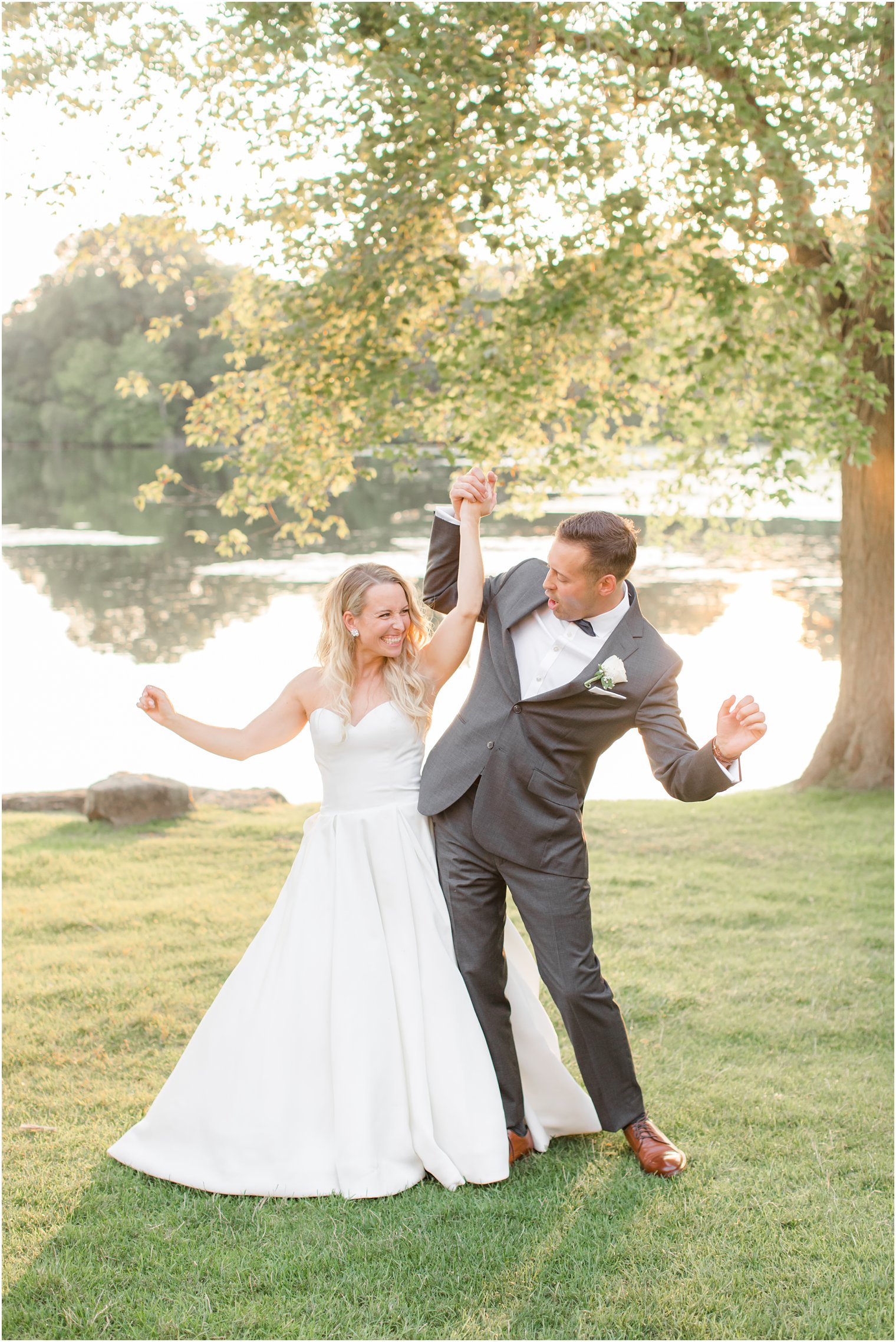 bride and groom bump hips during NJ wedding photos