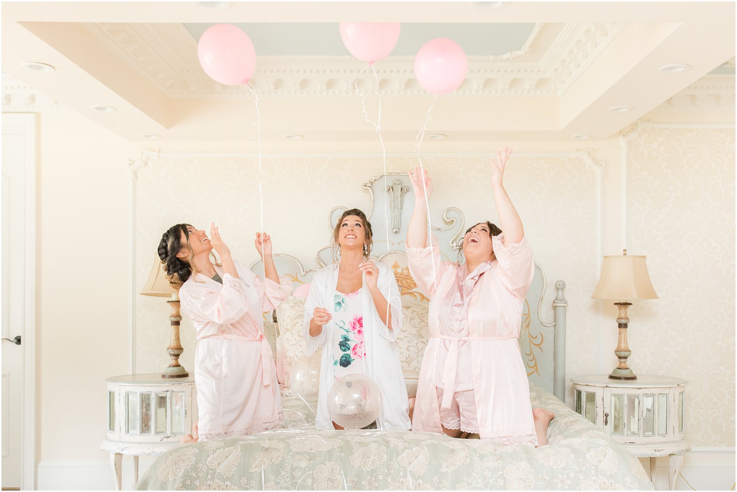 bride and bridesmaids release pink balloons before NJ wedding