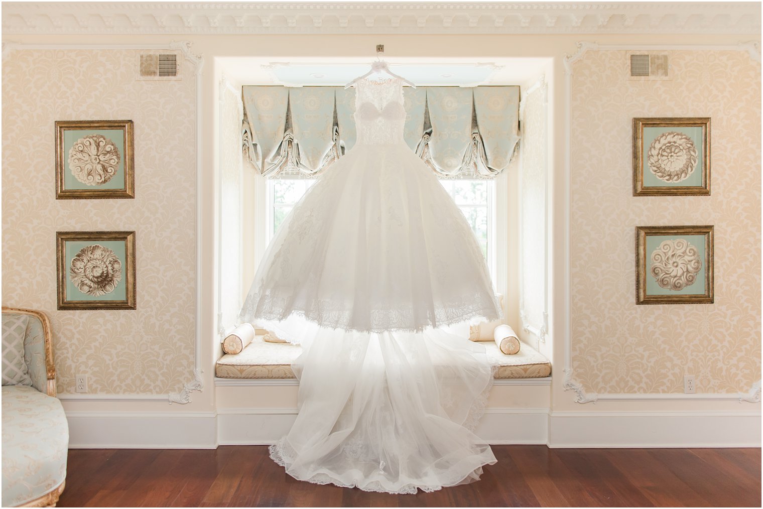 ballgown hangs in window of bridal suite at the Ashford Estate