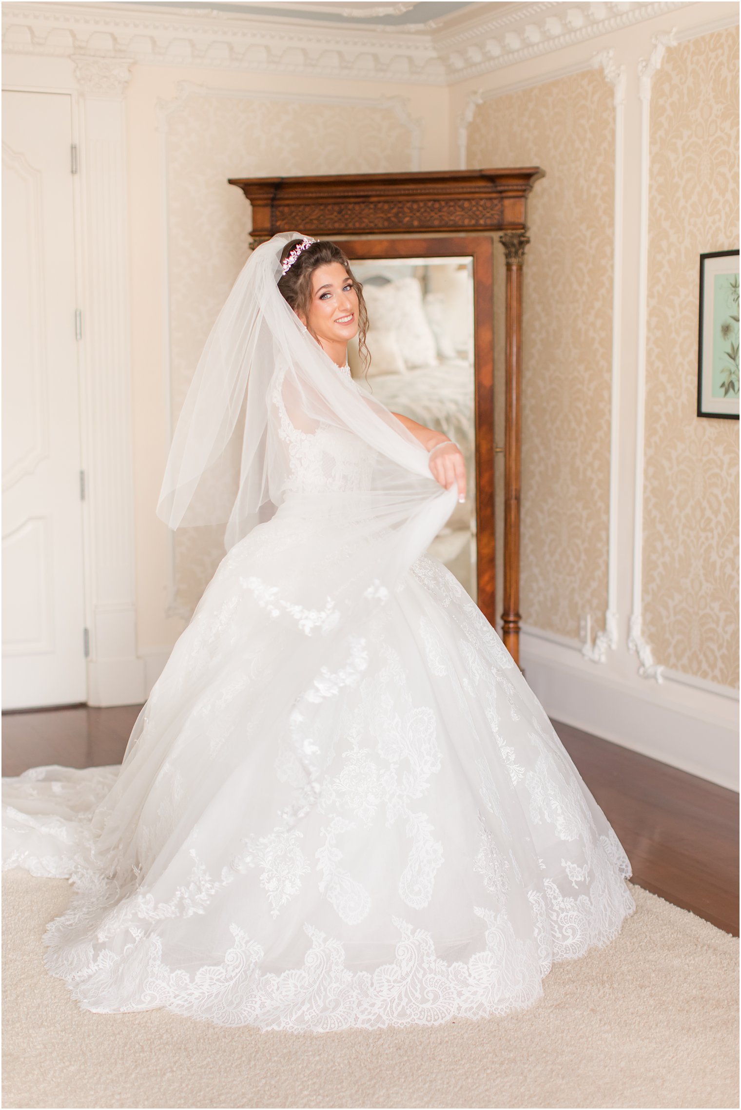 bride twirls in wedding dress and veil in bridal suite at Ashford Estate