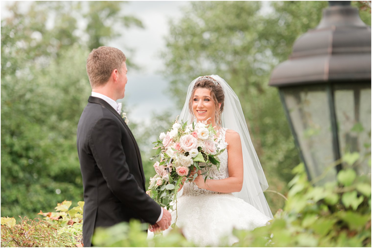 bride laughs at groom during first look in New Jersey