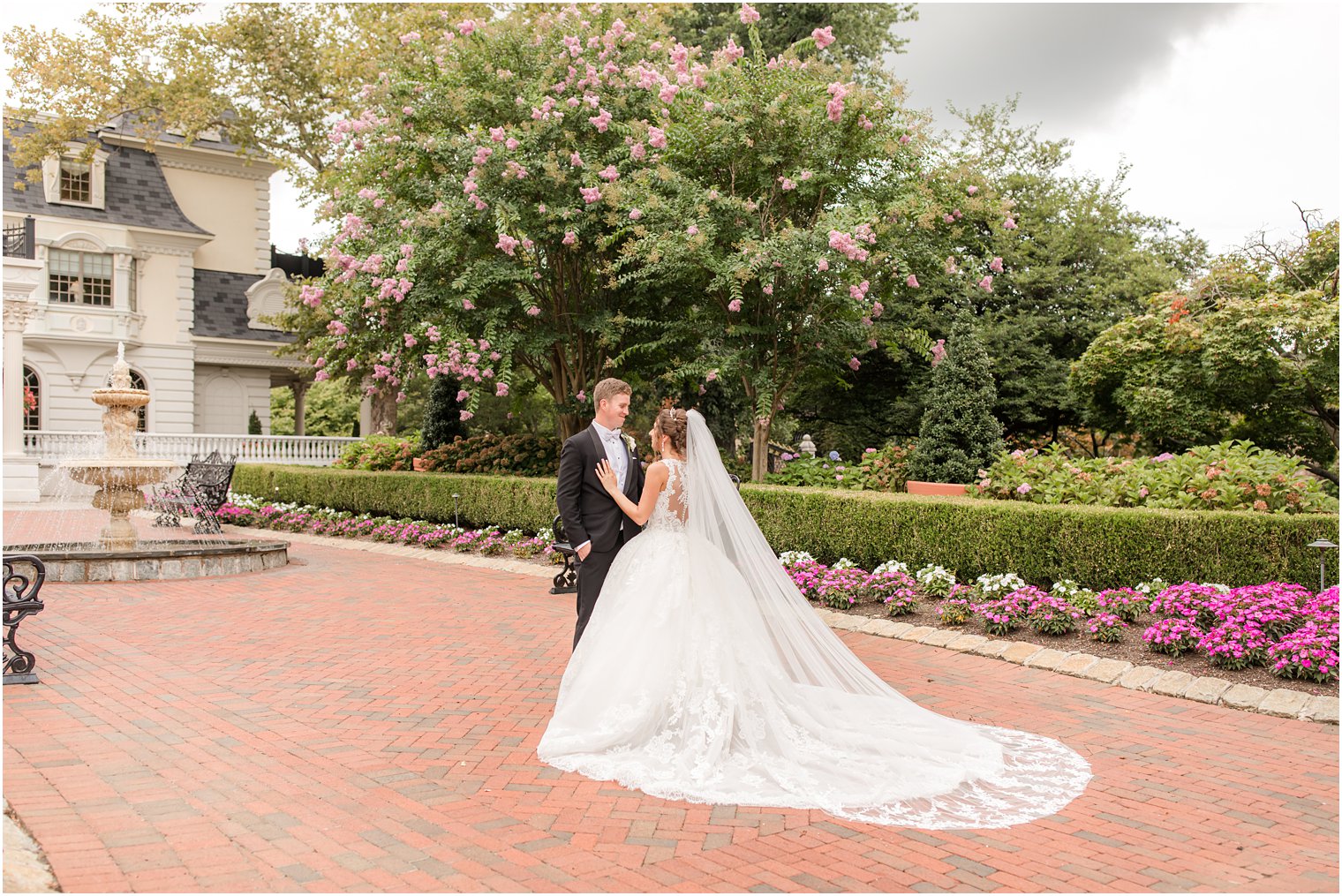 bride and groom stand on brick pathway in Allentown NJ