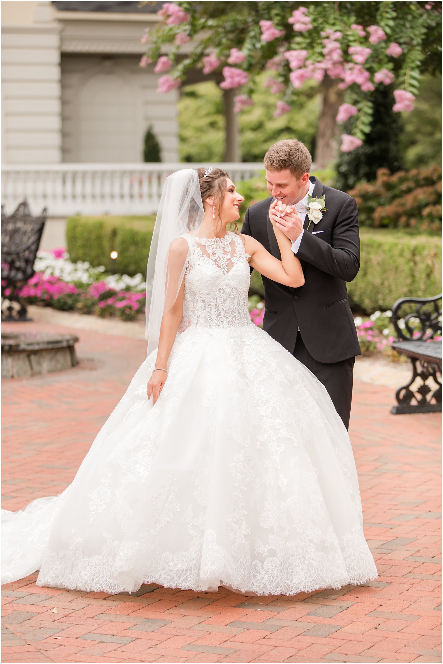 groom kisses bride's hand during NJ wedding photos 