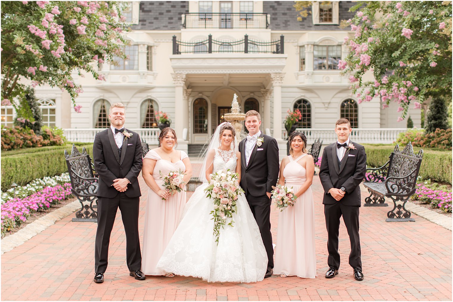 newlyweds pose with wedding party outside Ashford Estate