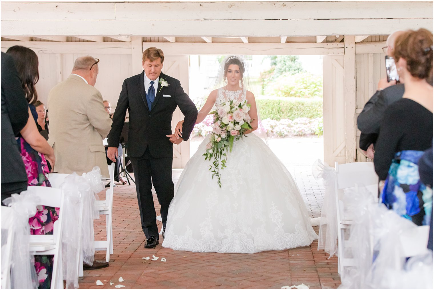 dad and daughter walk into wedding ceremony at Ashford Estate