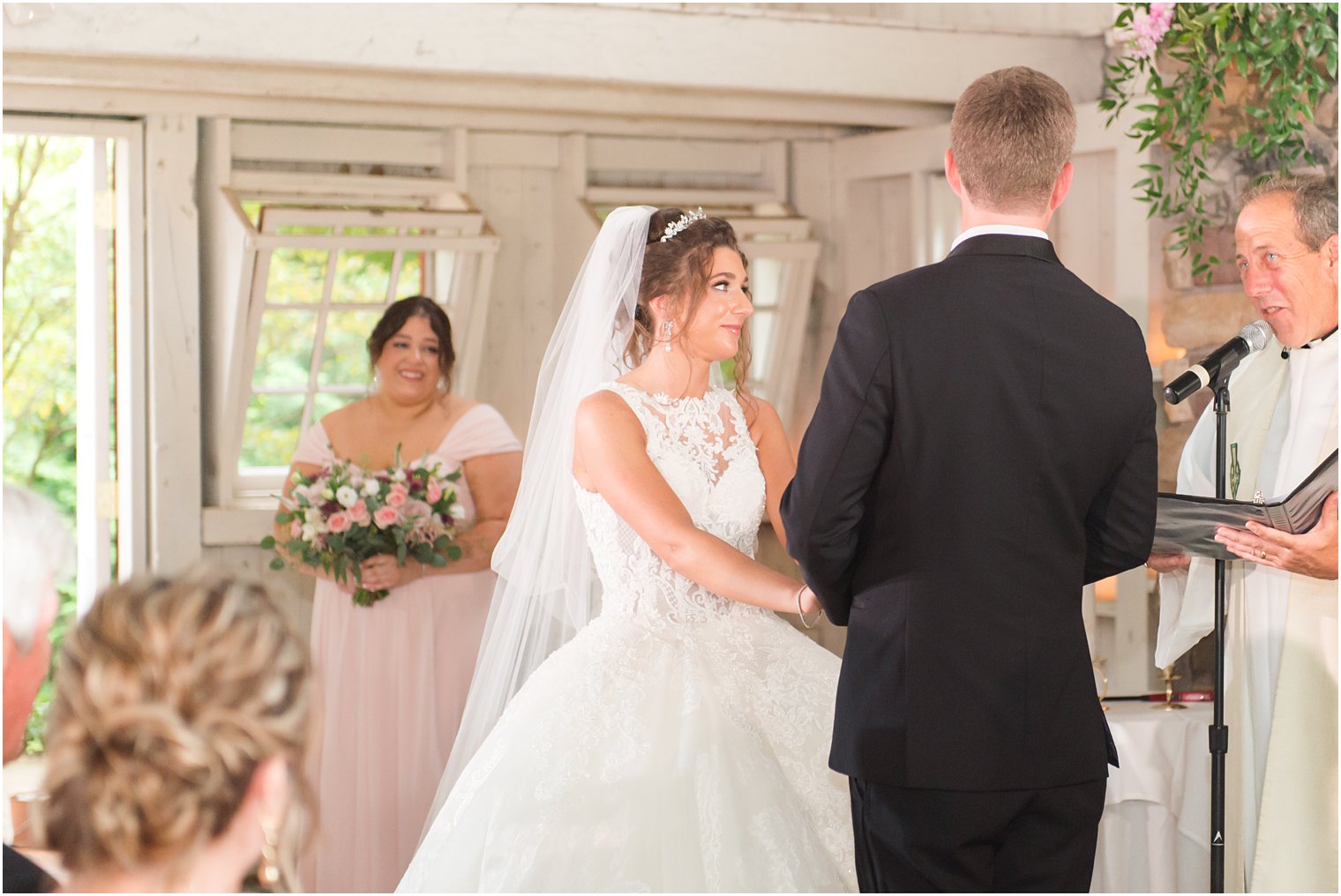 bride and groom look at officiant during ceremony in New Jersey