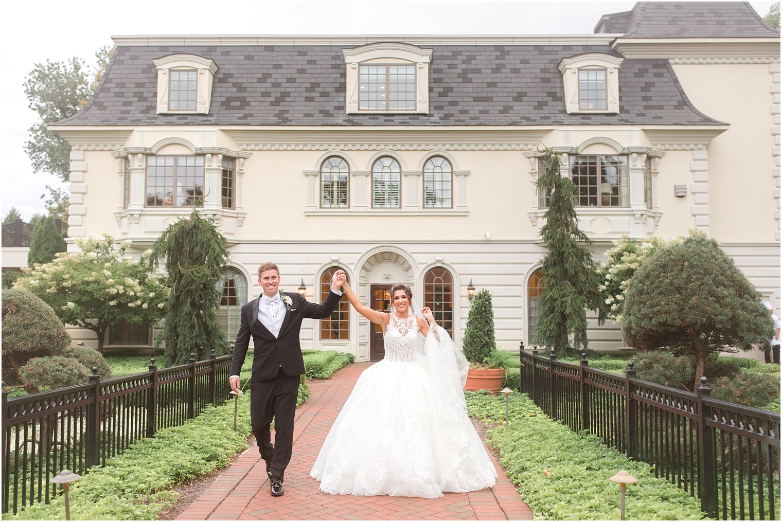 newlyweds cheer walking outside Ashford Estate