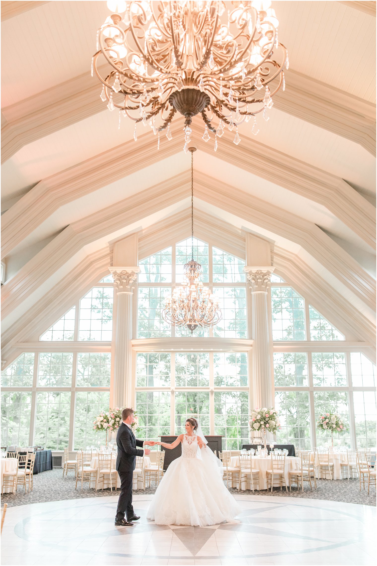 groom twirls bride in ballroom at Ashford Estate