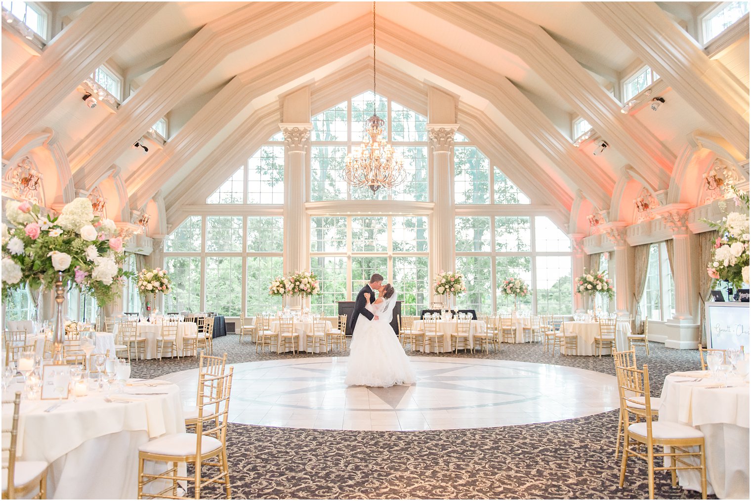 bride and groom kiss in ballroom at Ashford Estate