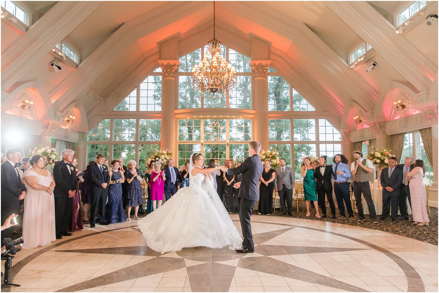 groom twirls bride on dance floor at Ashford Estate 