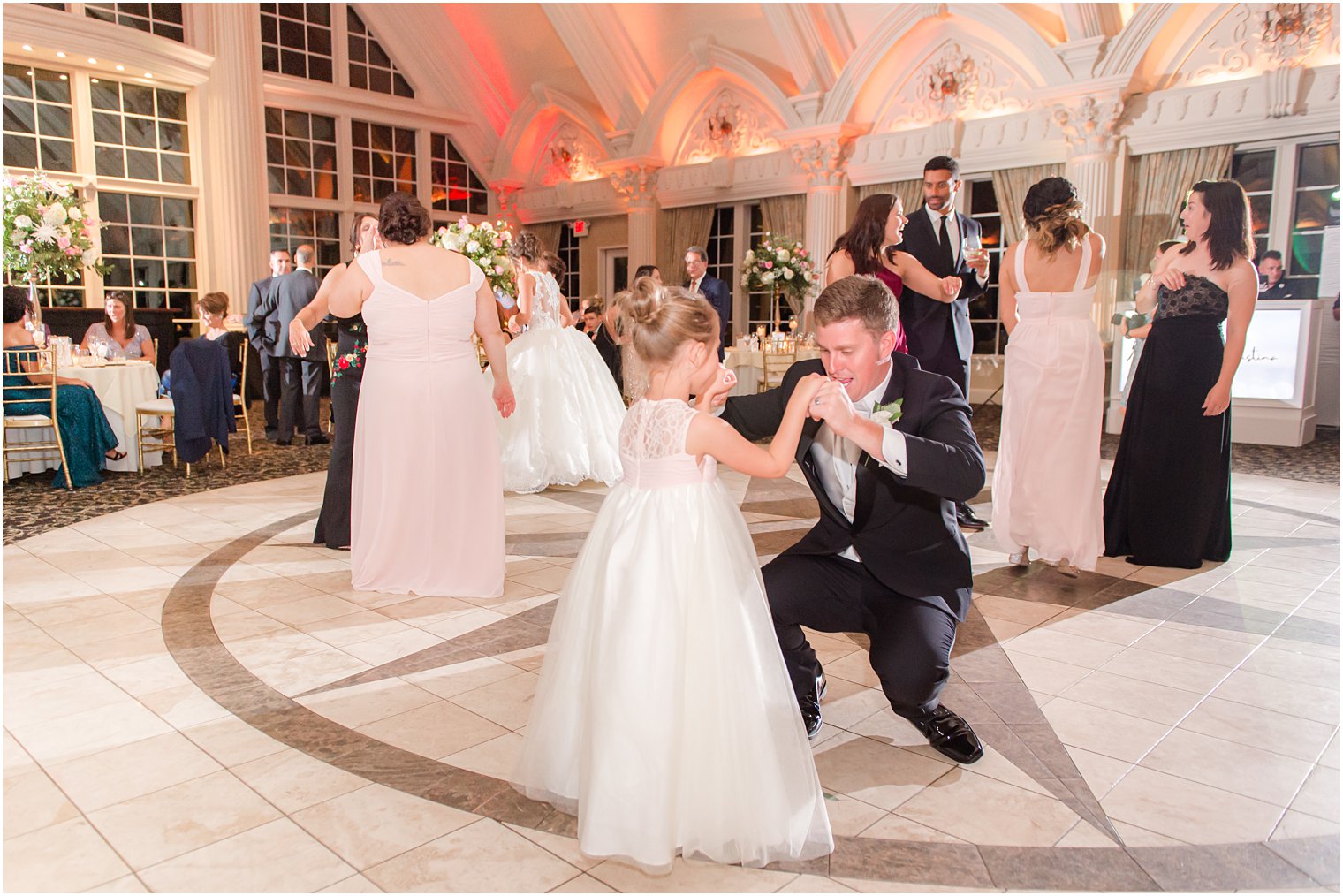 groom dances with flower girl during Allentown NJ wedding reception