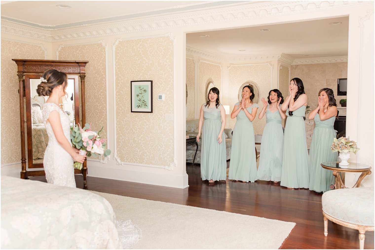 bride has first look with bridesmaids in sage green dresses