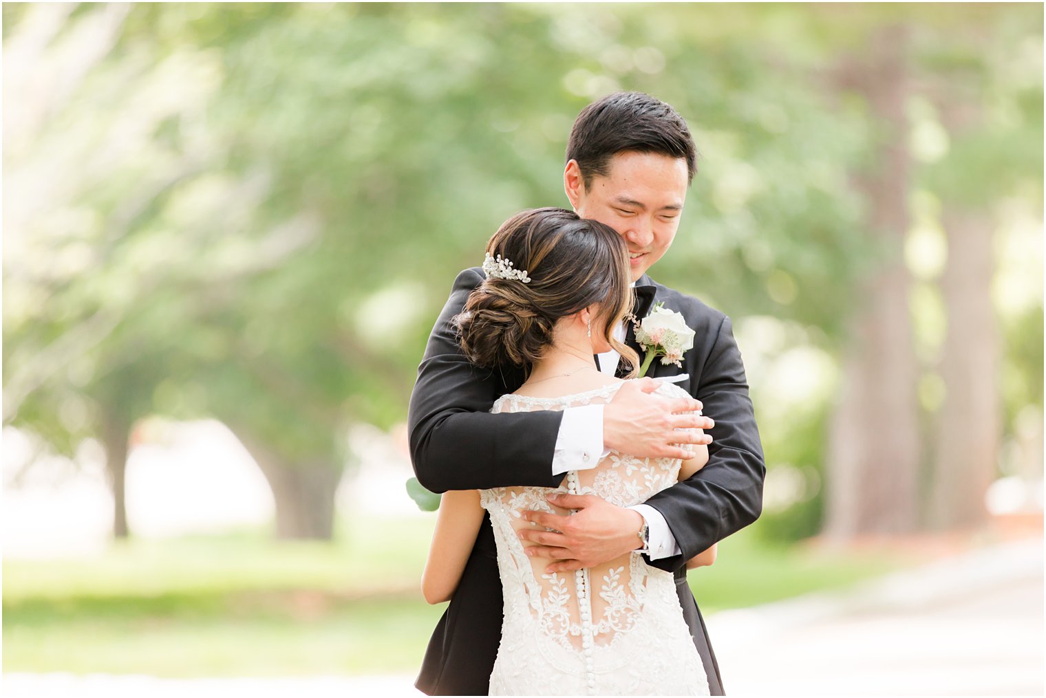 newlyweds hug during first look on driveway at Ashford Estate