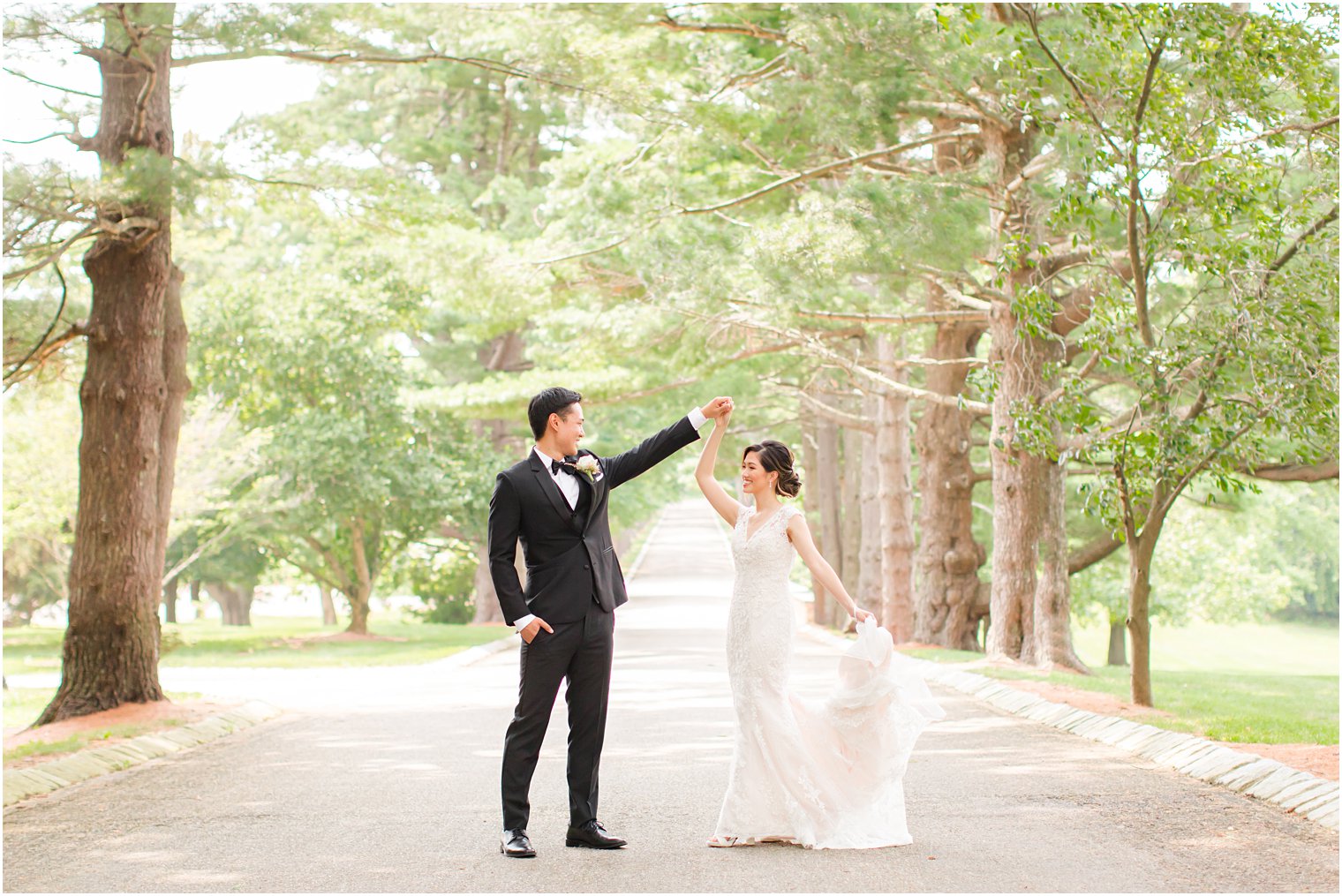 groom twirls bride on driveway in Ashford Estate