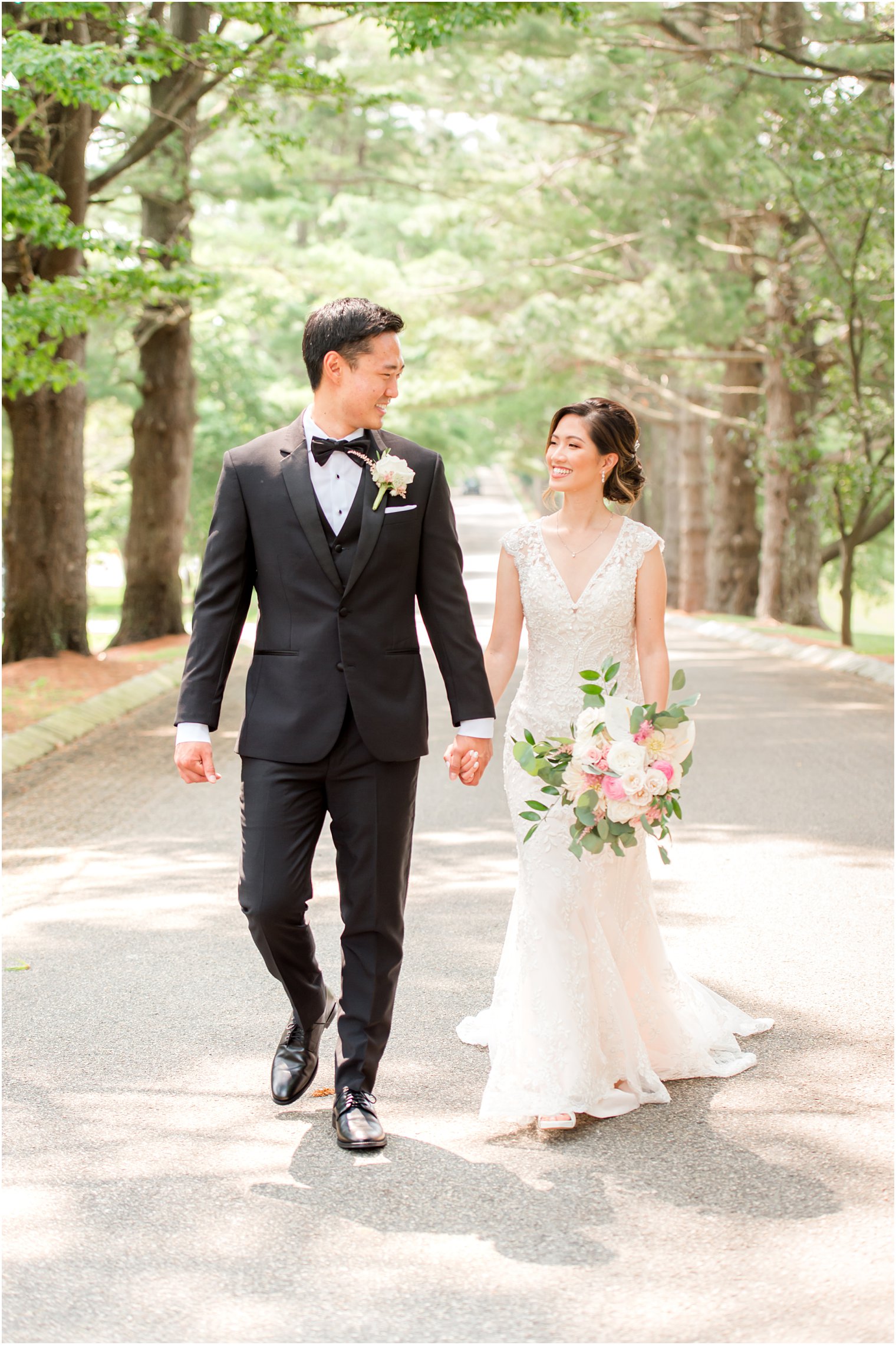 bride and groom hold hands walking down driveway at Ashford Estate