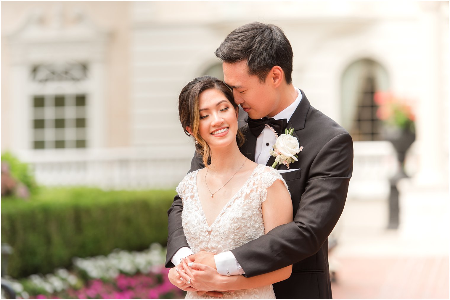 groom nuzzles bride's cheek outside Ashford Estate