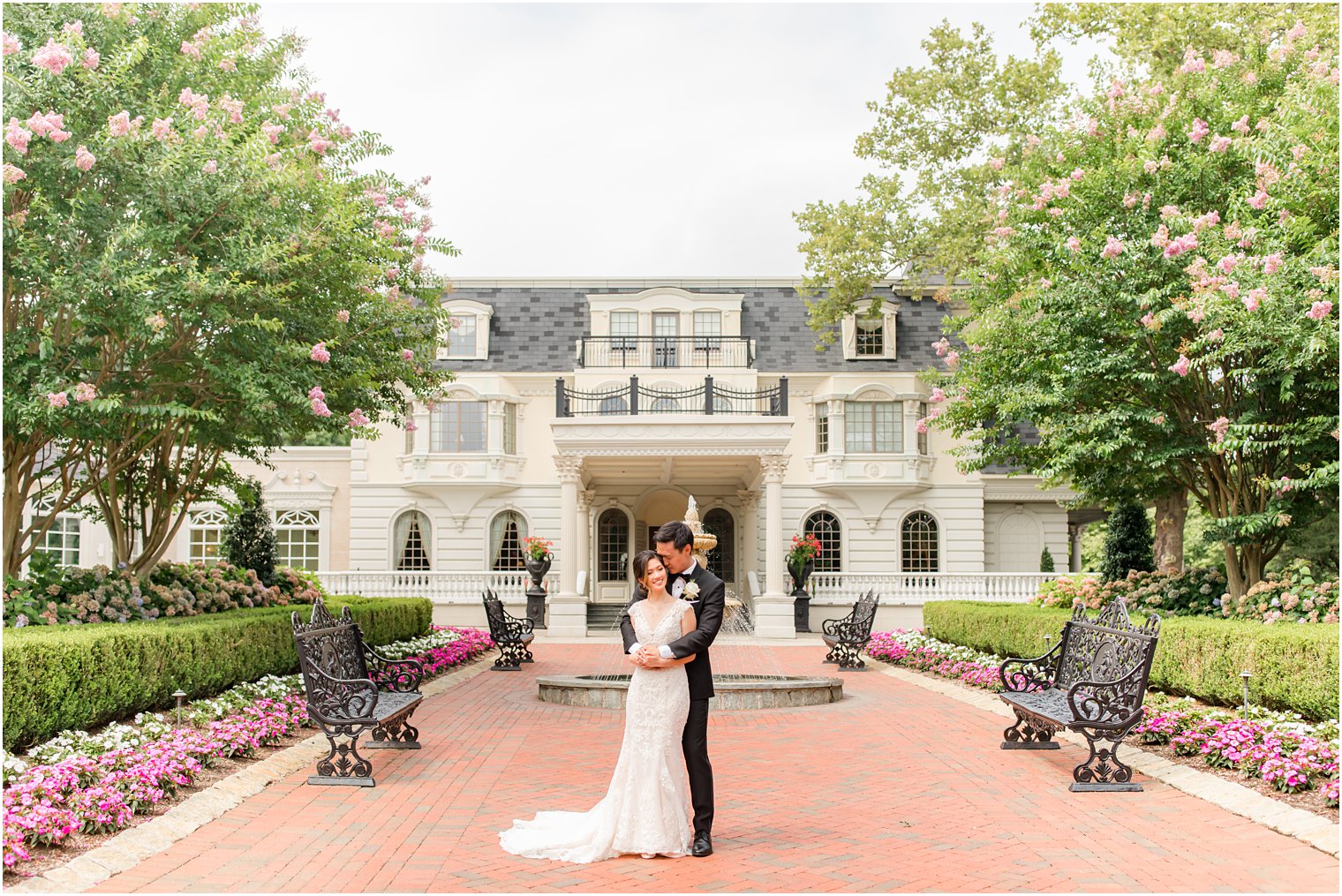 newlyweds hug outside Ashford Estate by fountain