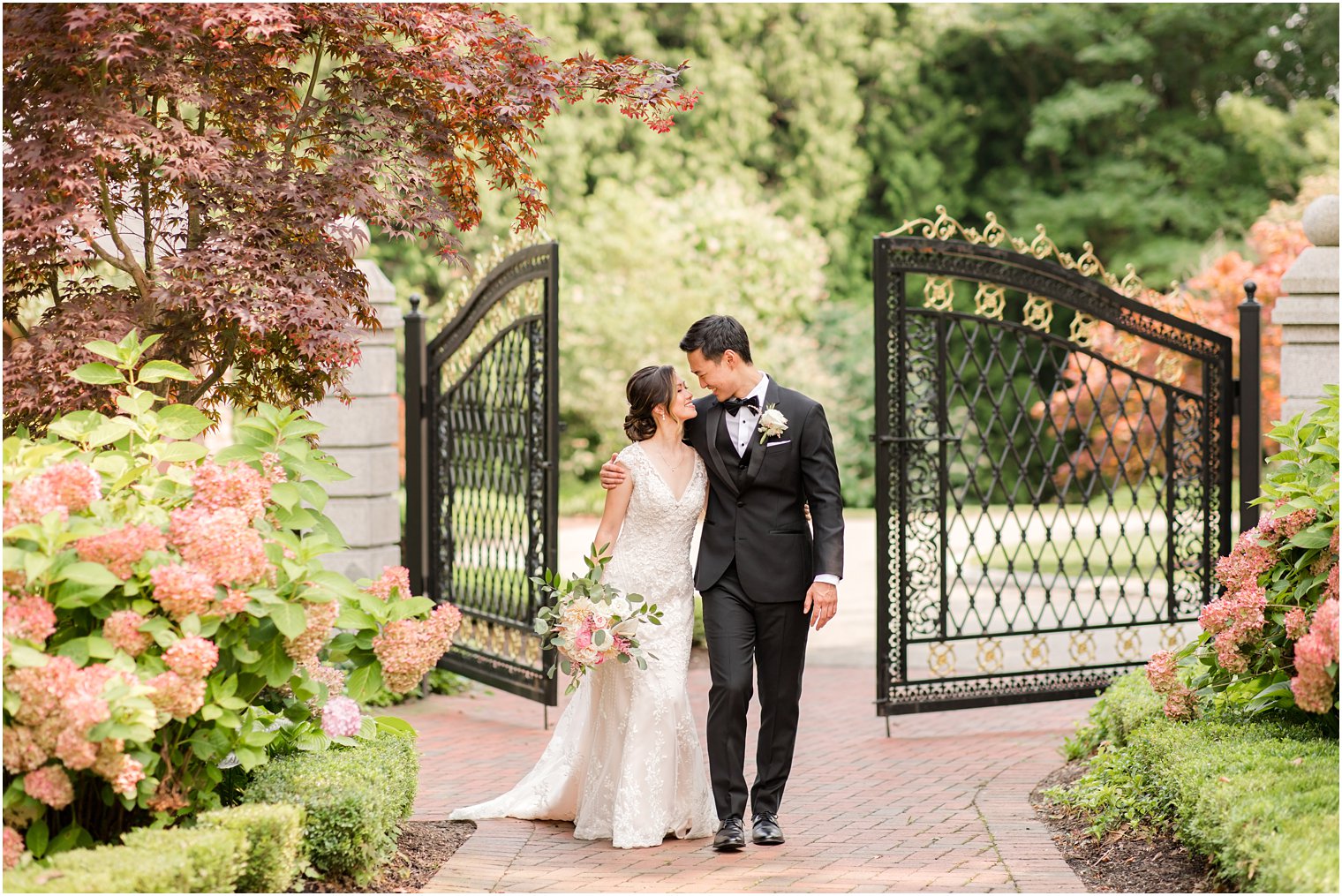 newlyweds walk away from wrought iron gate at Ashford Estate