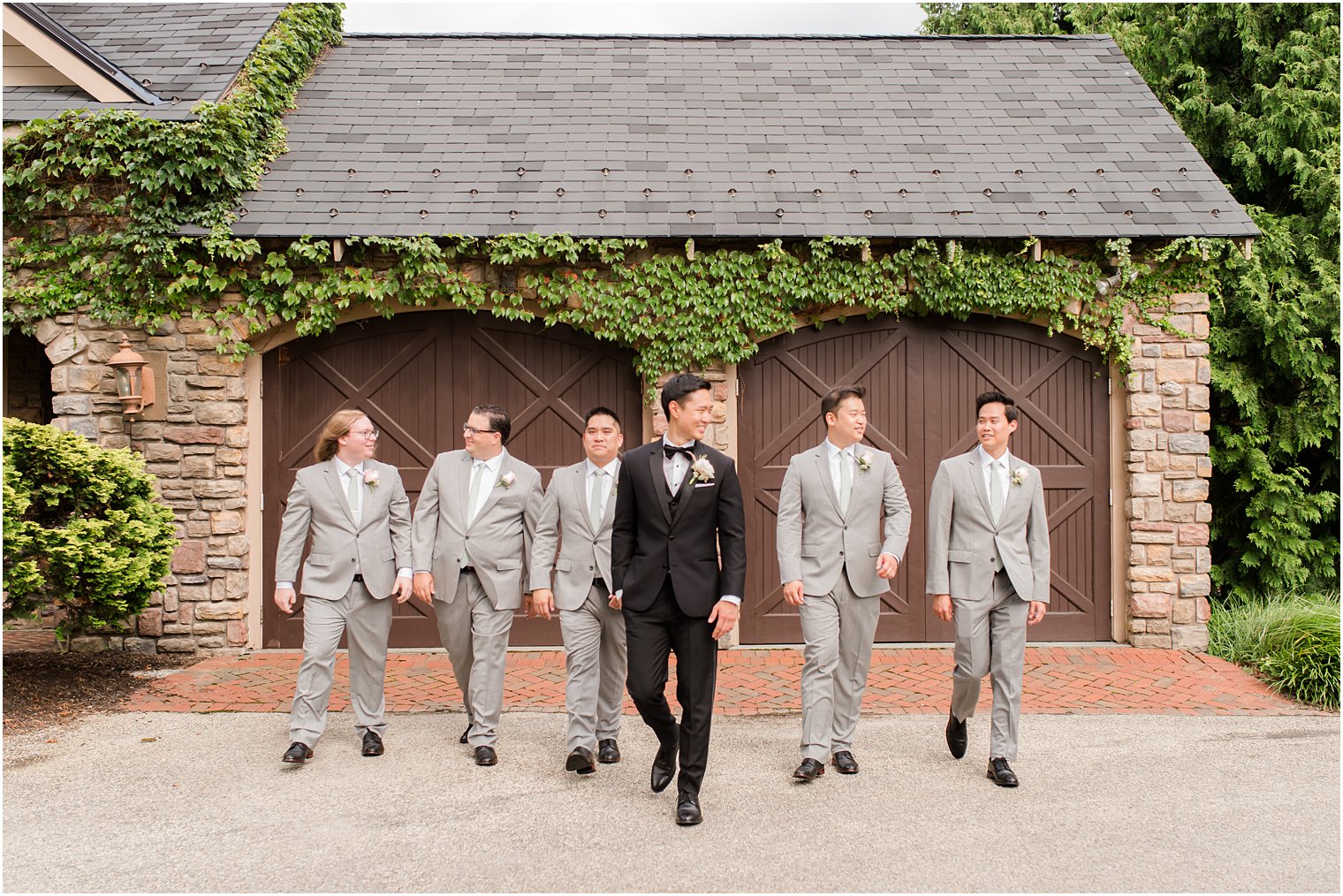 groom and groomsmen walk outside Ashford Estate in Allentown NJ