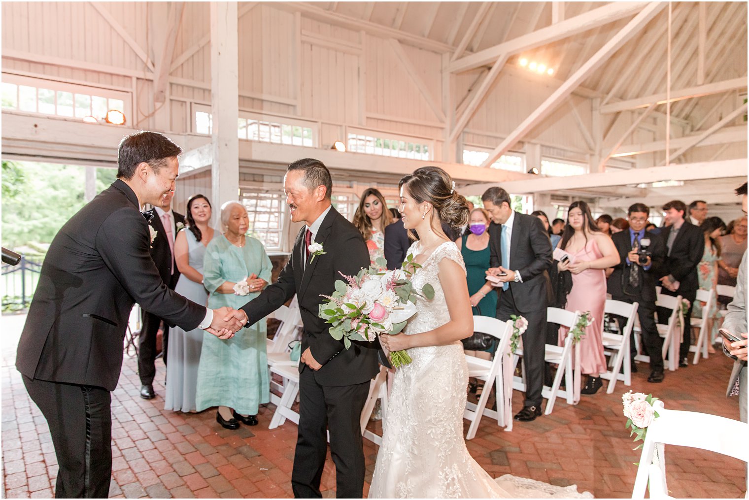 father gives bride away during NJ wedding ceremony at Ashford Estate 