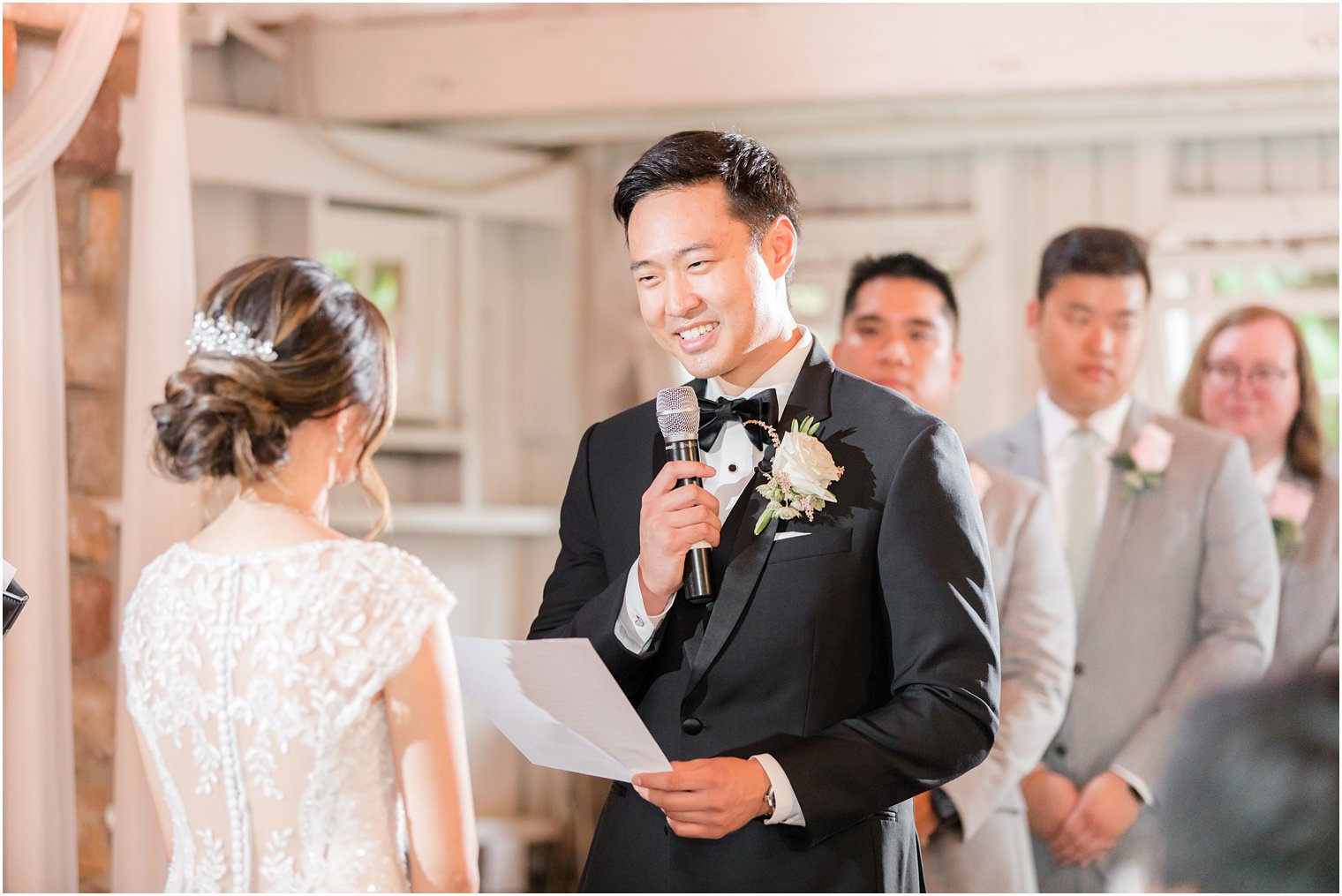 groom reads vows to bride during NJ wedding ceremony 