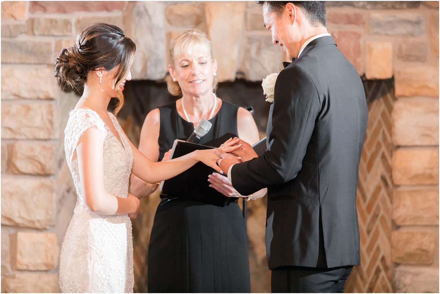 groom gives bride ring during wedding ceremony in New Jersey 