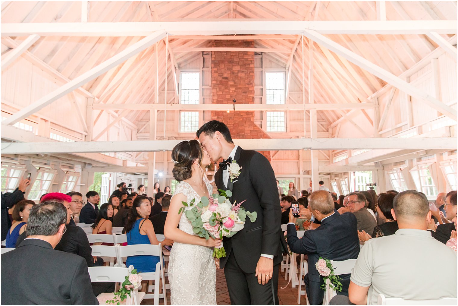 bride and groom kiss at the end of the aisle after Ashford Estate wedding ceremony 