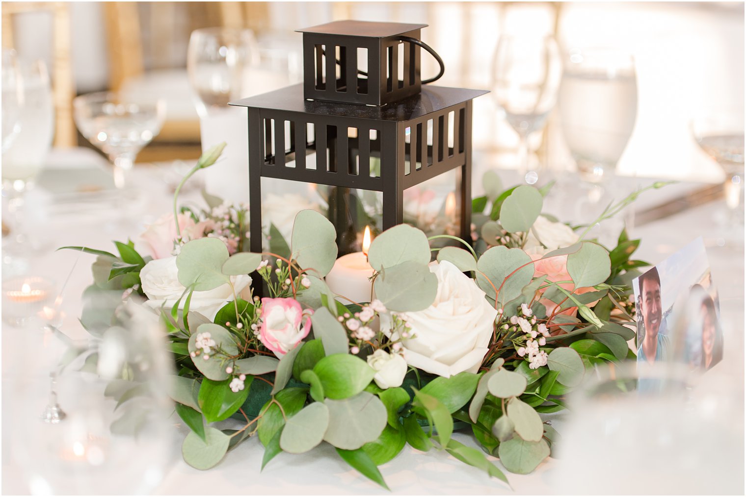 centerpieces for NJ wedding reception with black lanterns in white flowers 