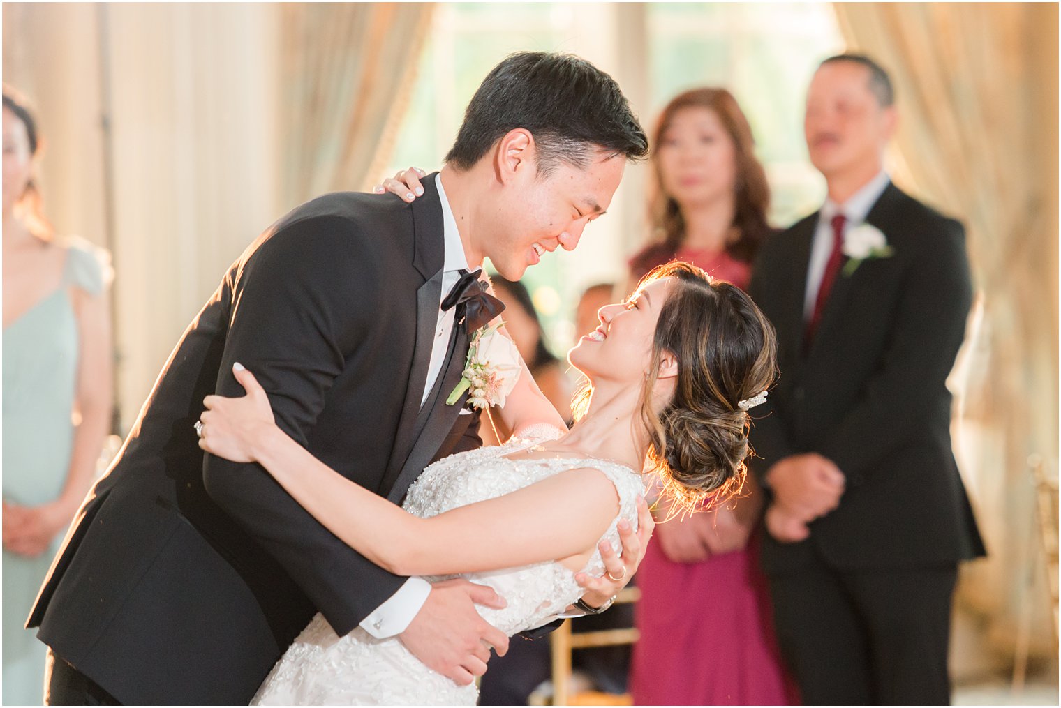 groom dips bride during first dance in New Jersey ballroom 