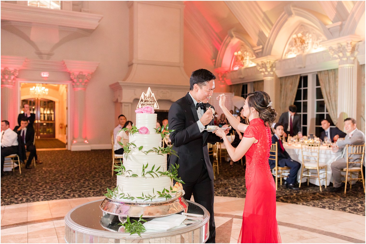 bride and groom eat wedding cake during NJ wedding reception 