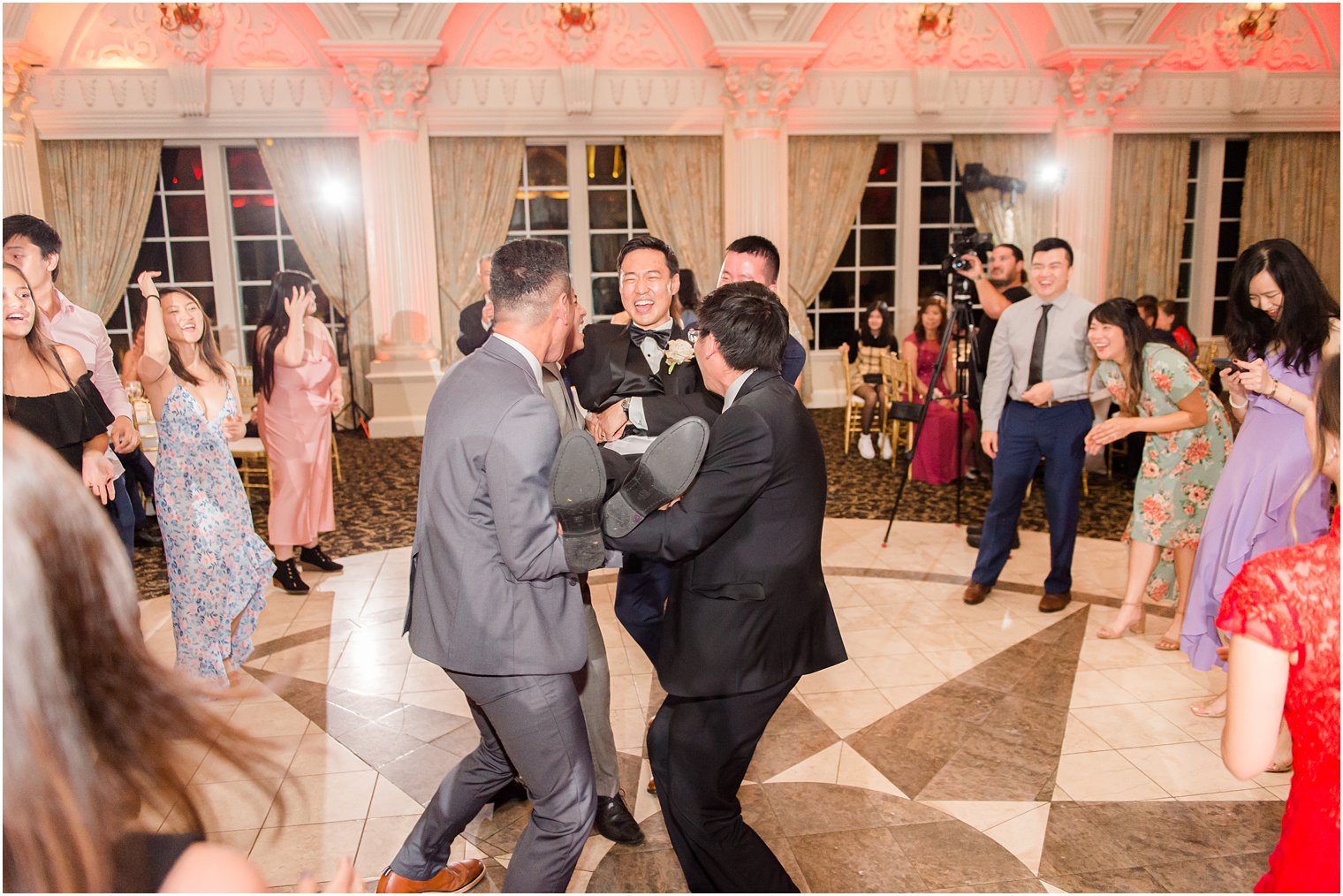 guests pick up groom during NJ wedding reception dancing