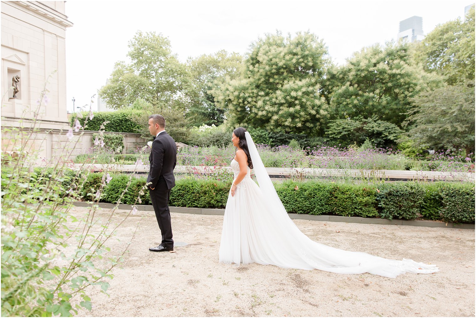 bride approaches groom for first look in garden of Rodin Museum