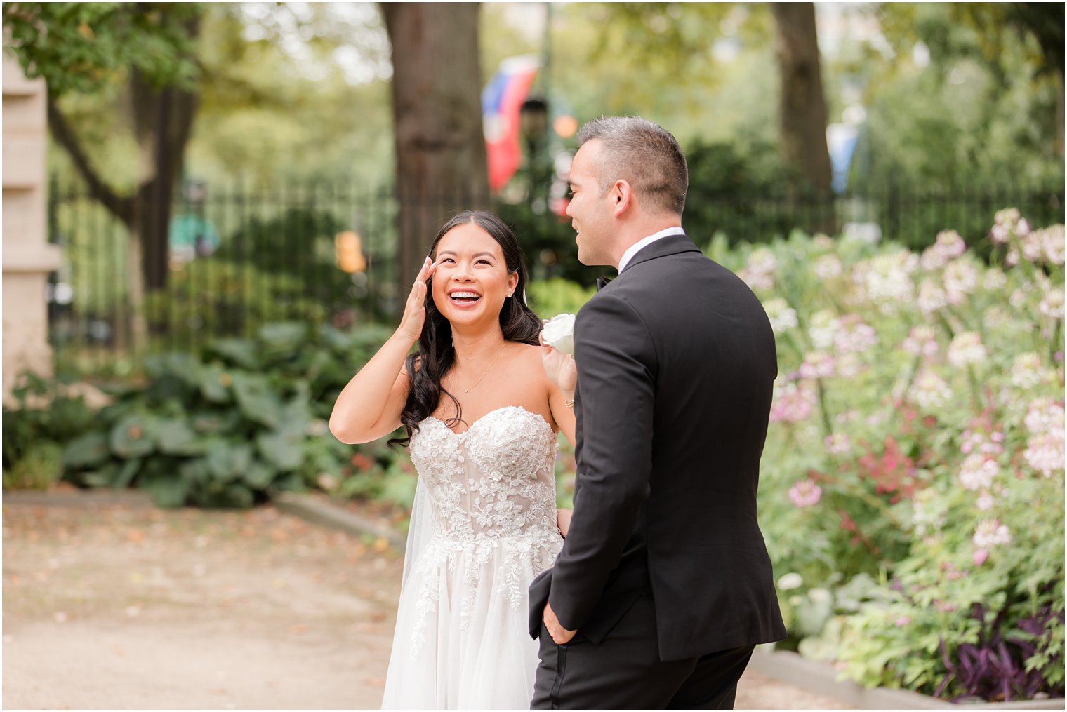 bride wipes tear during first look in garden