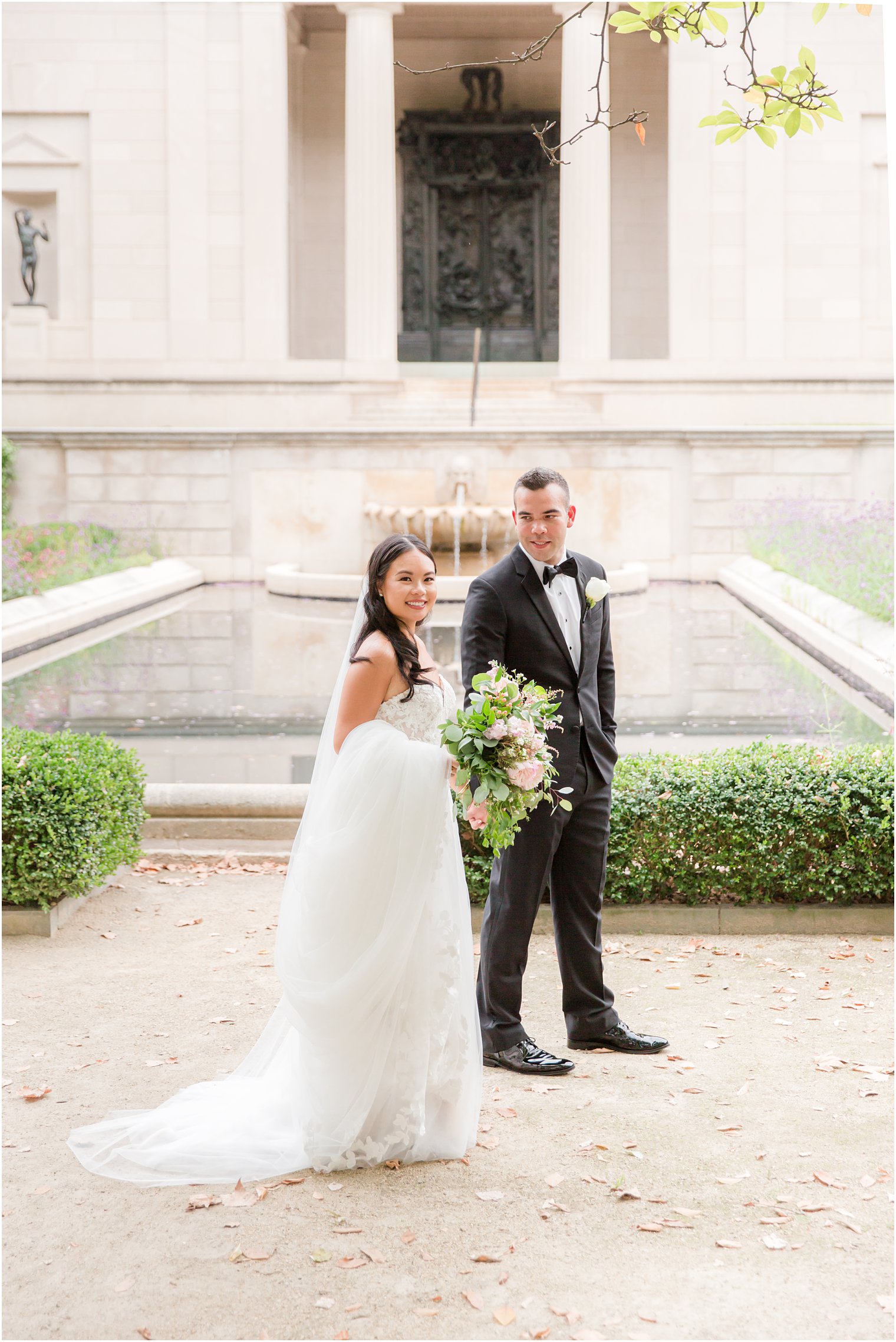 newlyweds walk through gardens of Rodin Museum