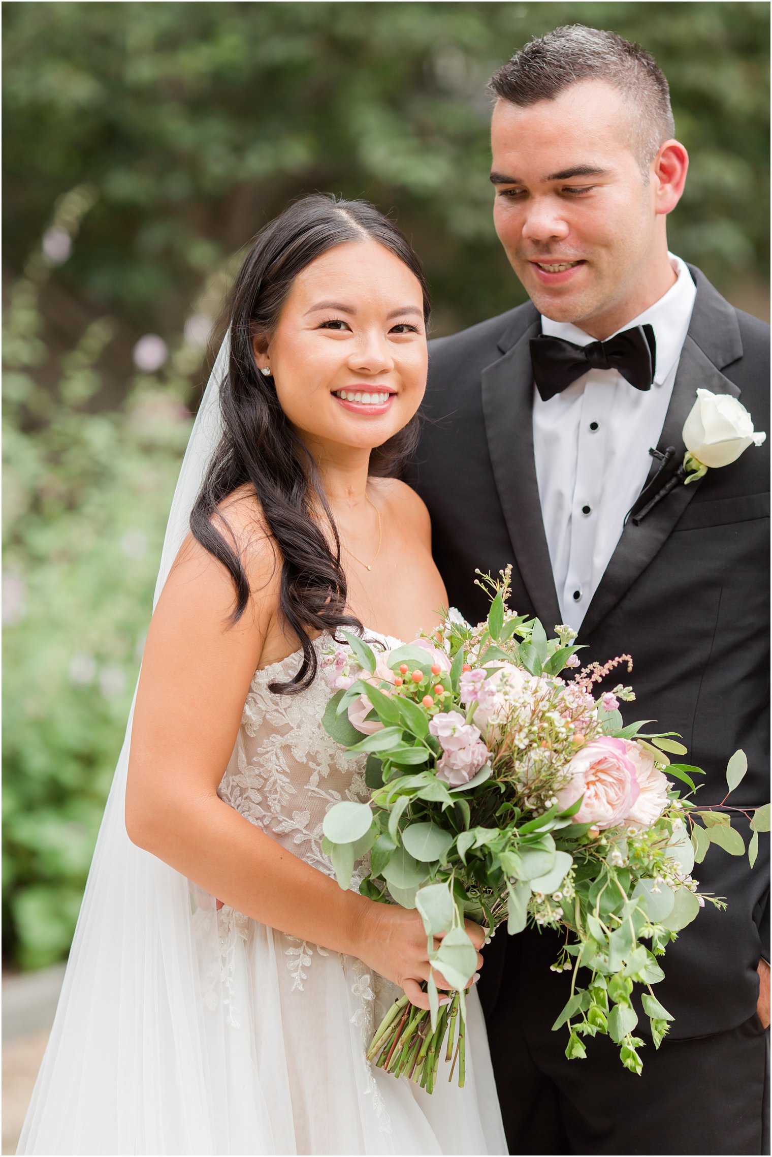 groom smiles down at bride during PA wedding photos at Rodin Museum