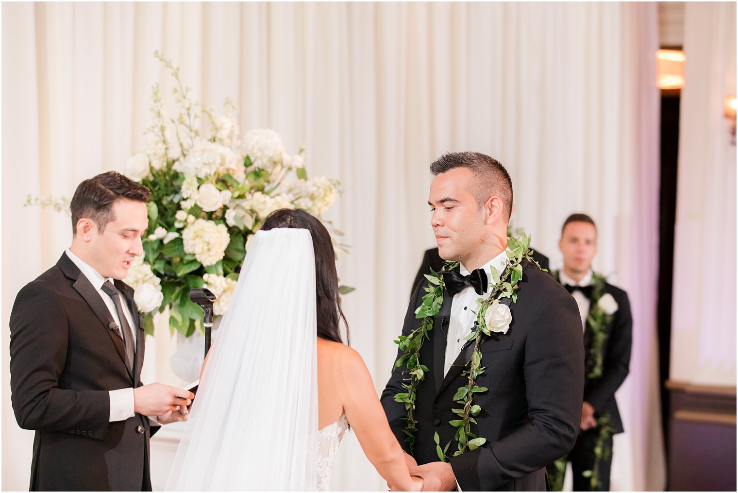 bride and groom hold hands during Ballroom at the Ben wedding ceremony