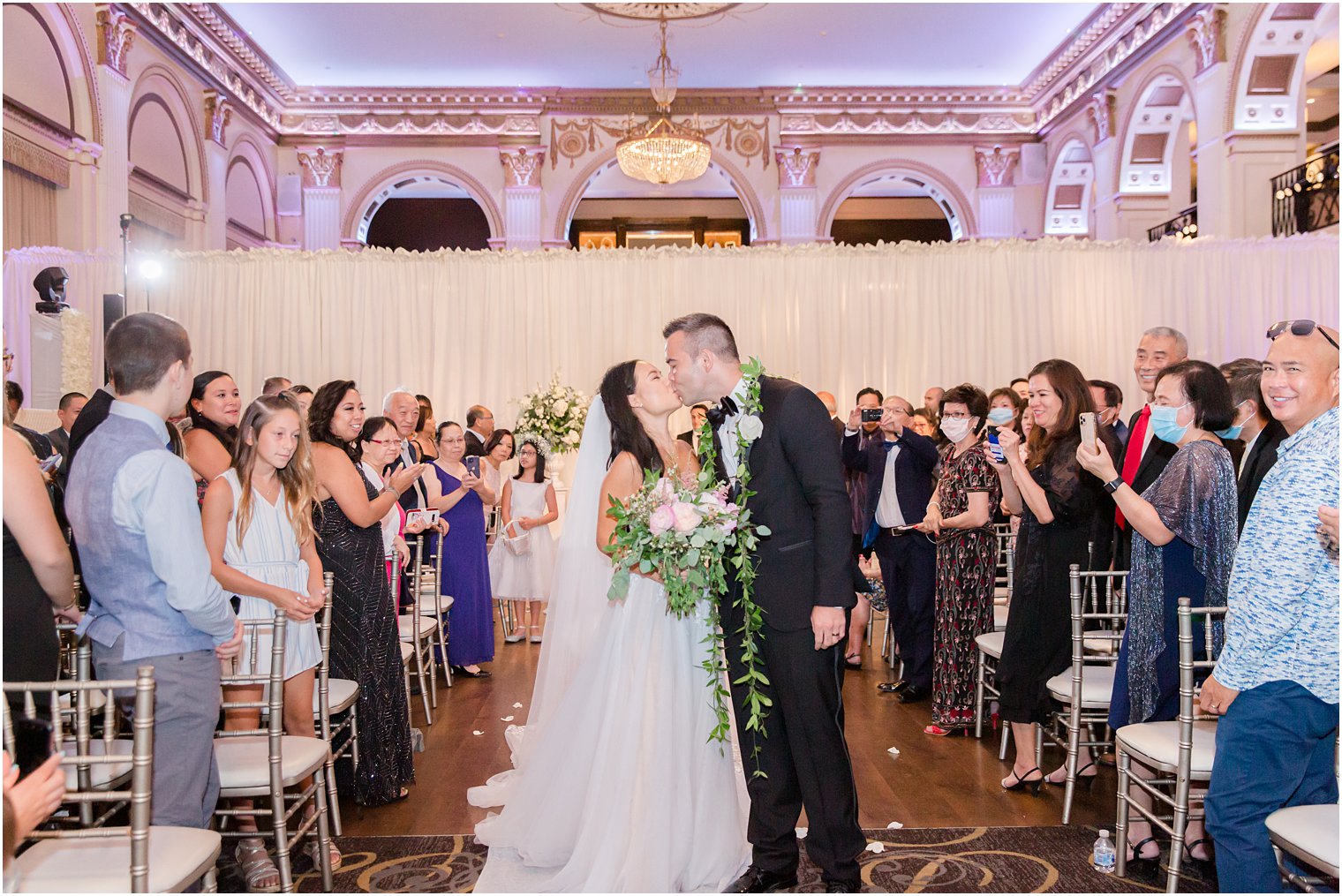 bride and groom kiss during Ballroom at the Ben wedding ceremony