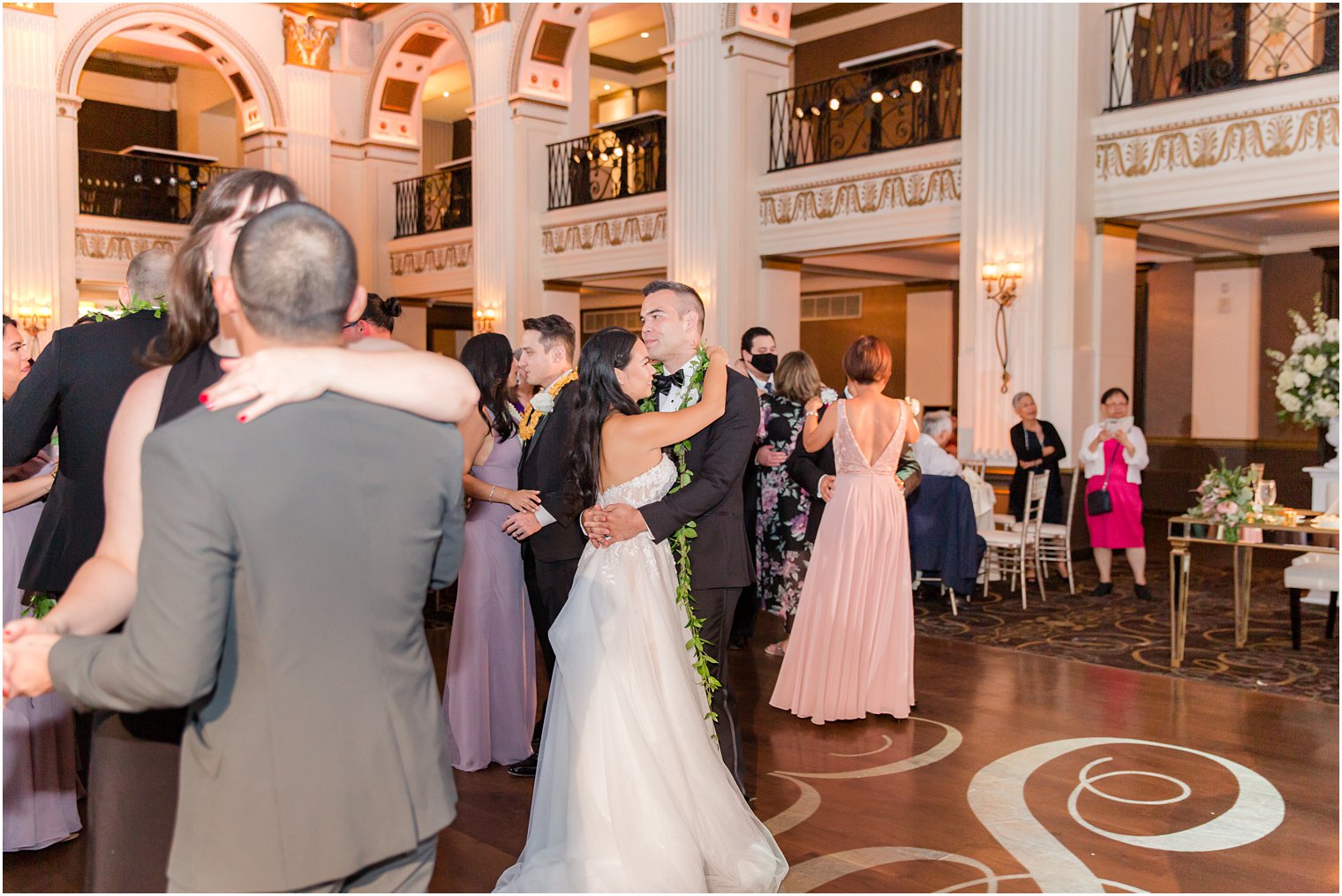 bride and groom dance during Philly PA wedding reception with guests