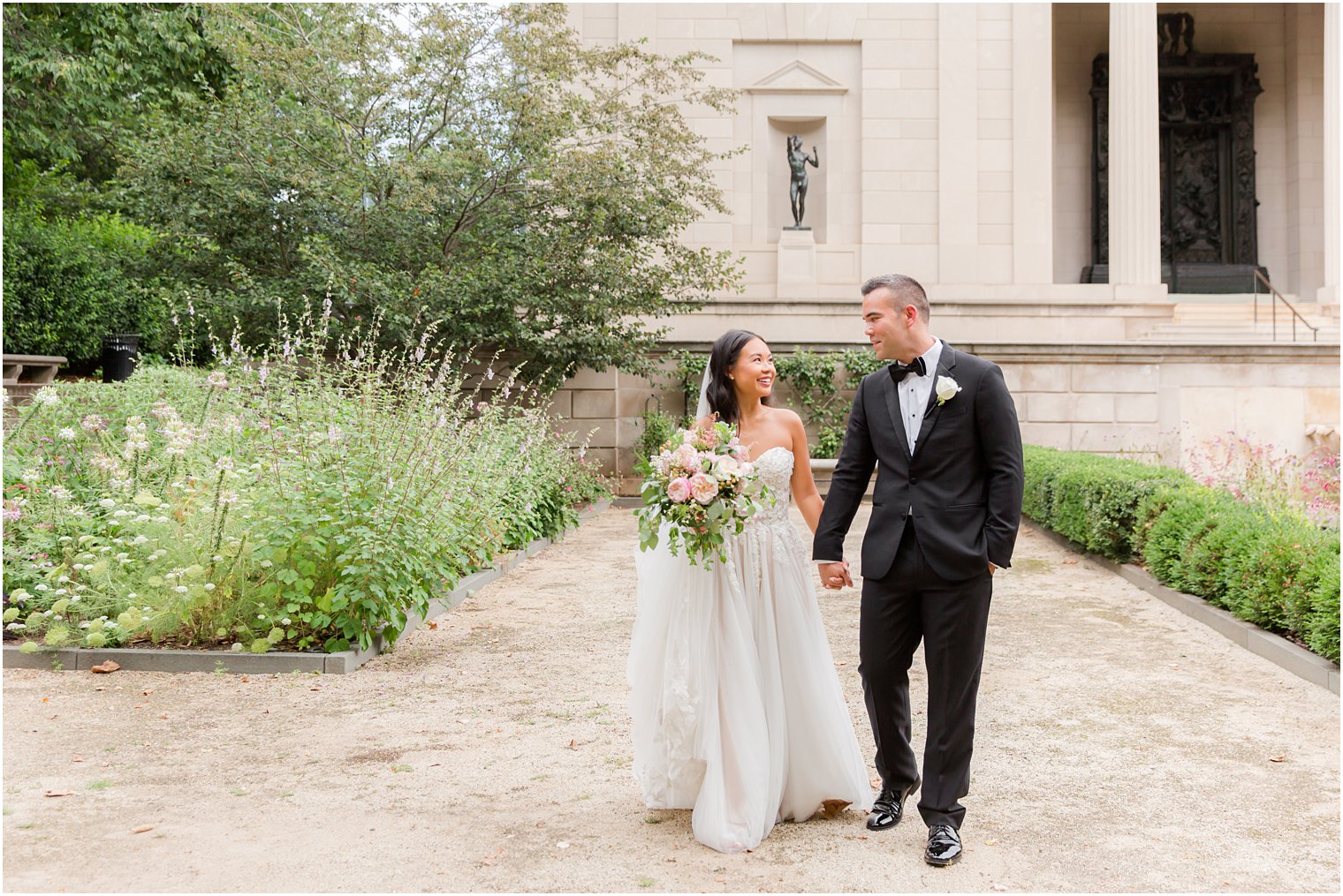 newlyweds walk through gardens at Rodin Museum