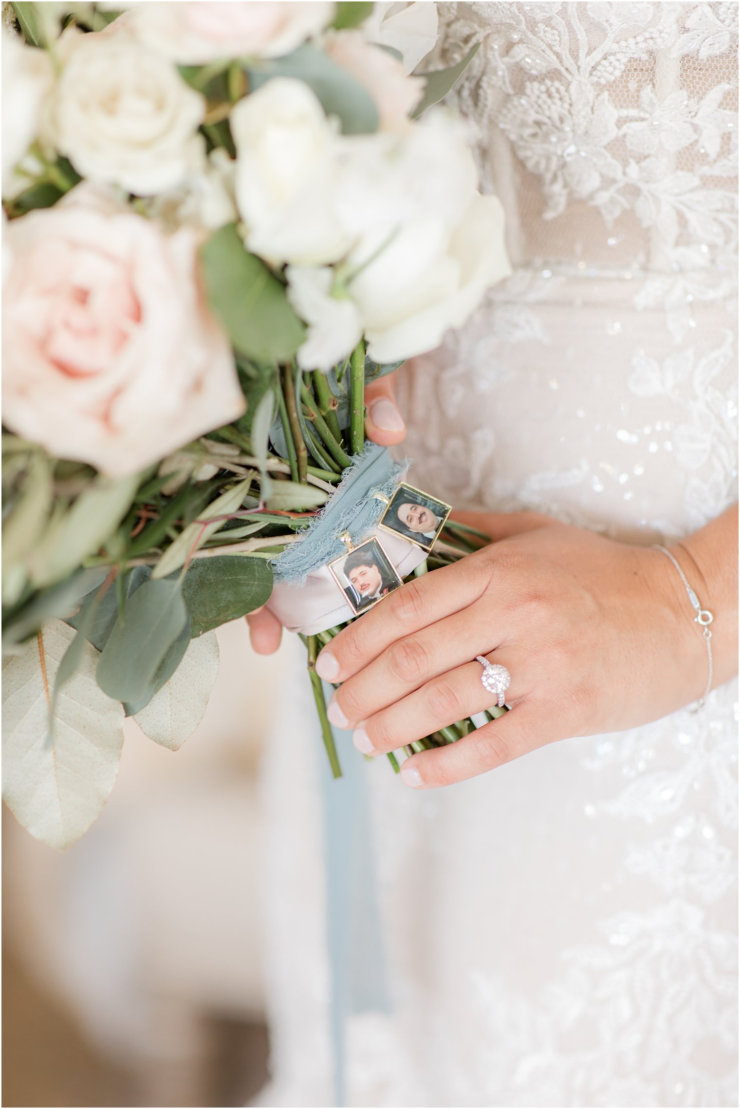bride holds bouquet with locket photos of family 