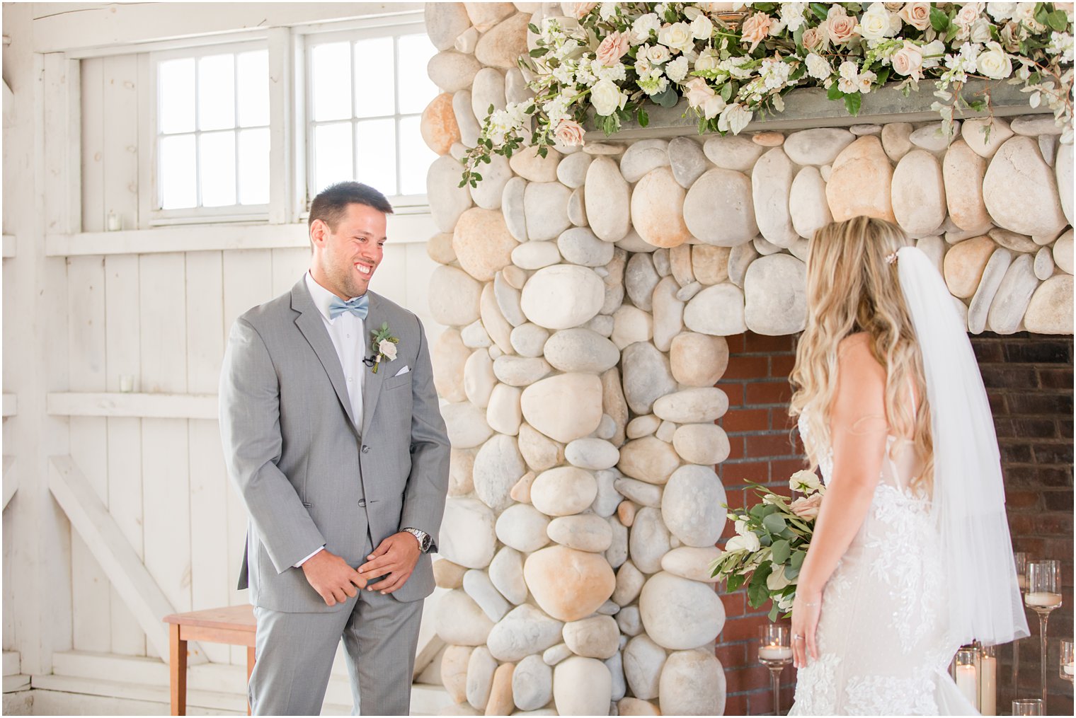 groom smiles at bride during first look in NJ