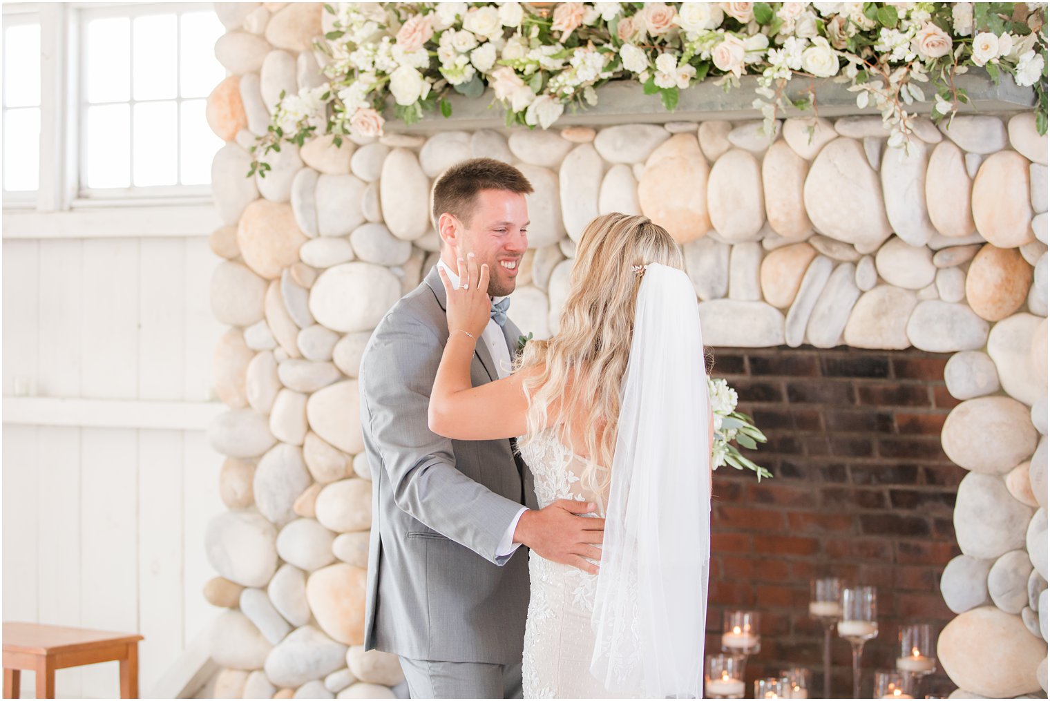 bride wipes away tears for groom during first look at Bonnet Island Estate