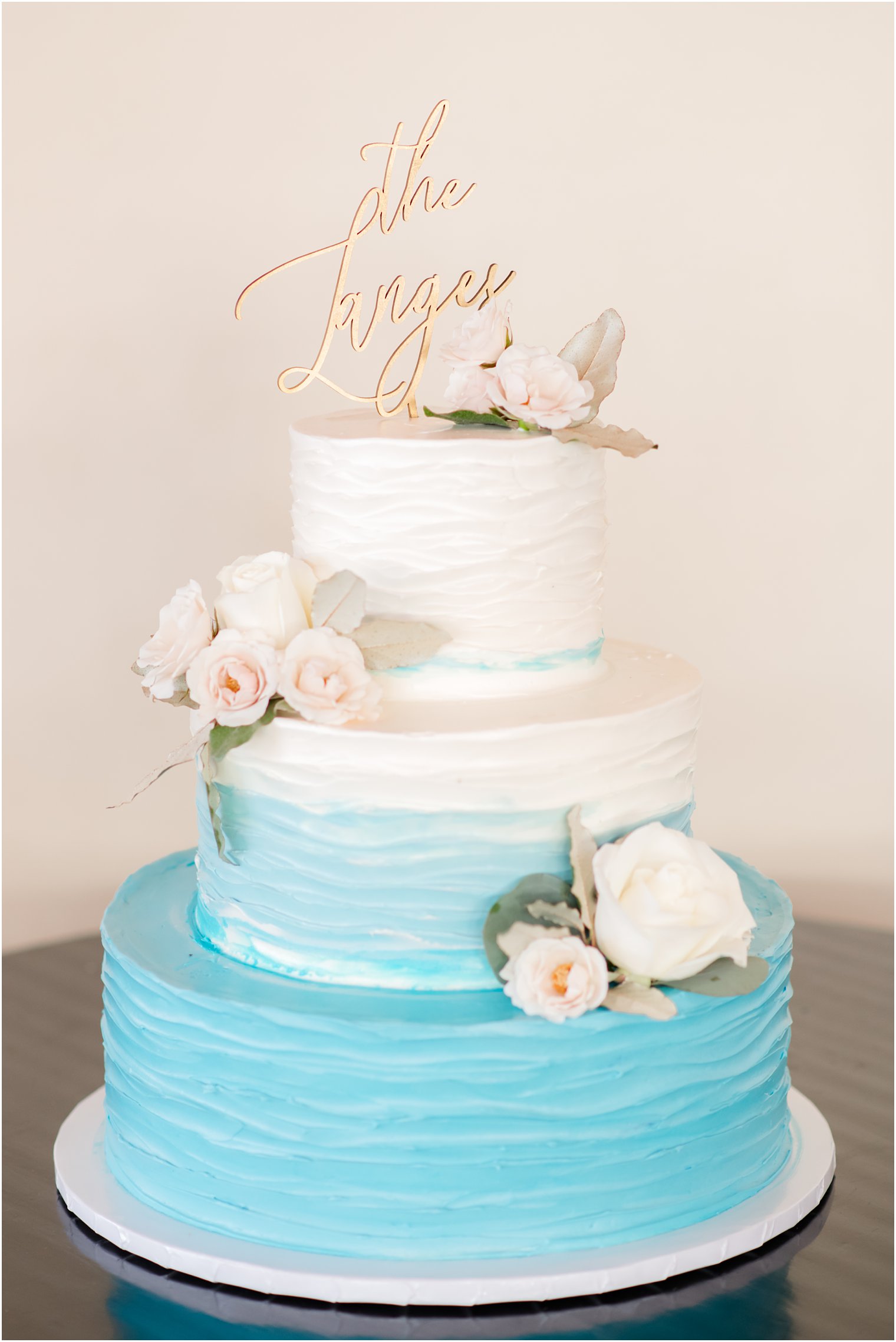 tiered wedding cake with ombre blue icing 