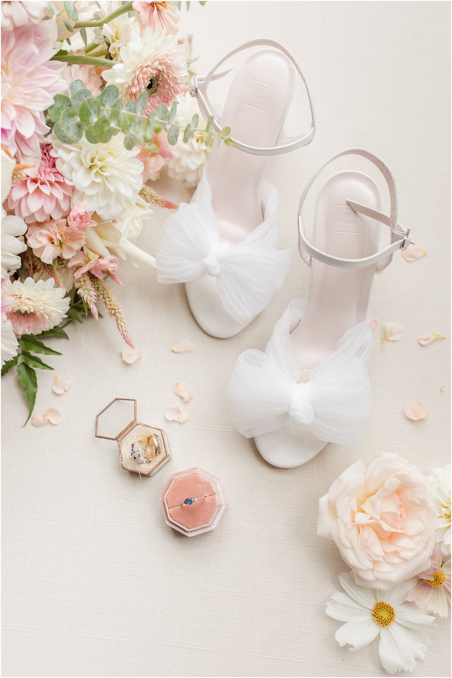 wedding rings sit in pink and gold cases before Chauncey Hotel wedding