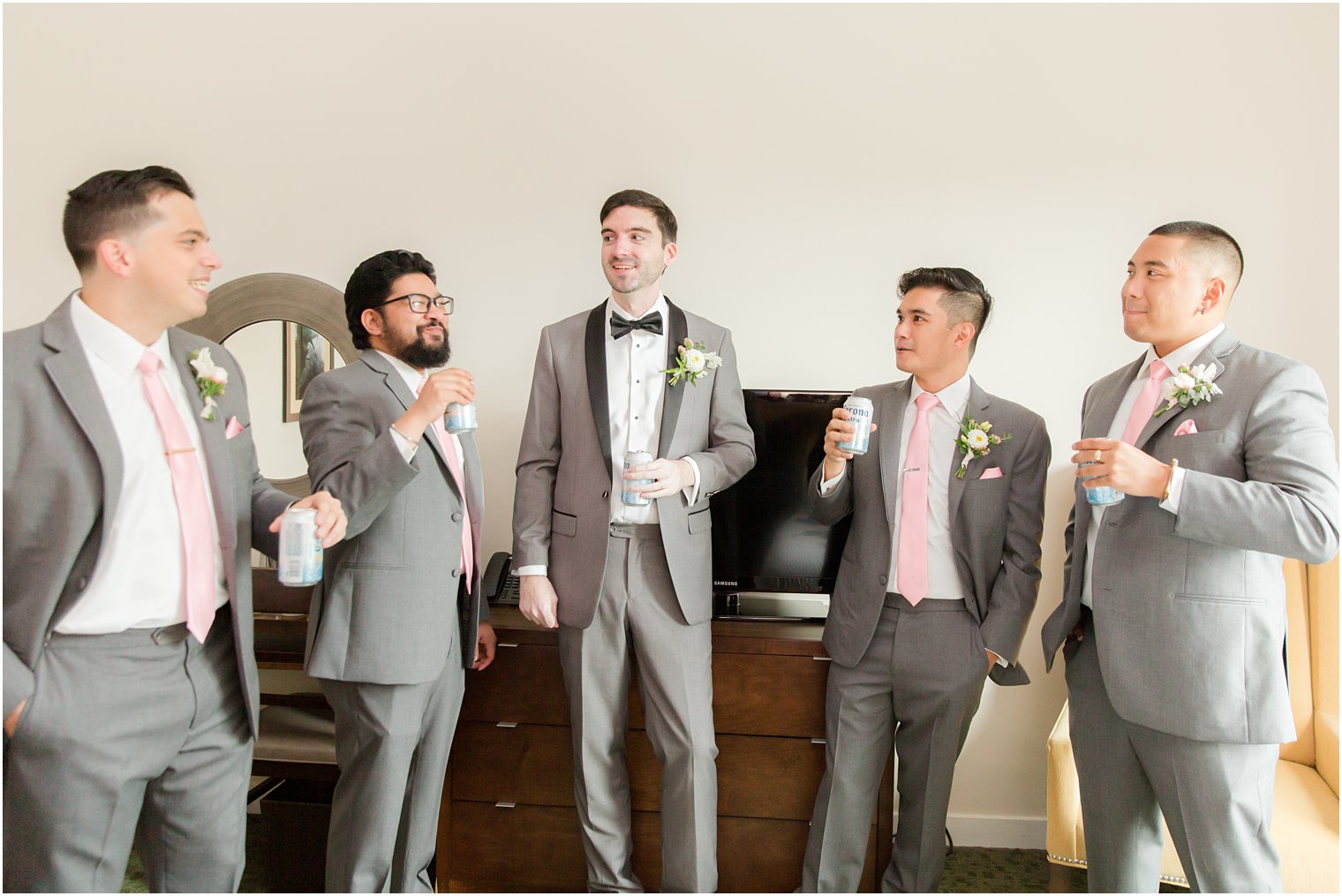 groom stands with groomsmen before NJ wedding day