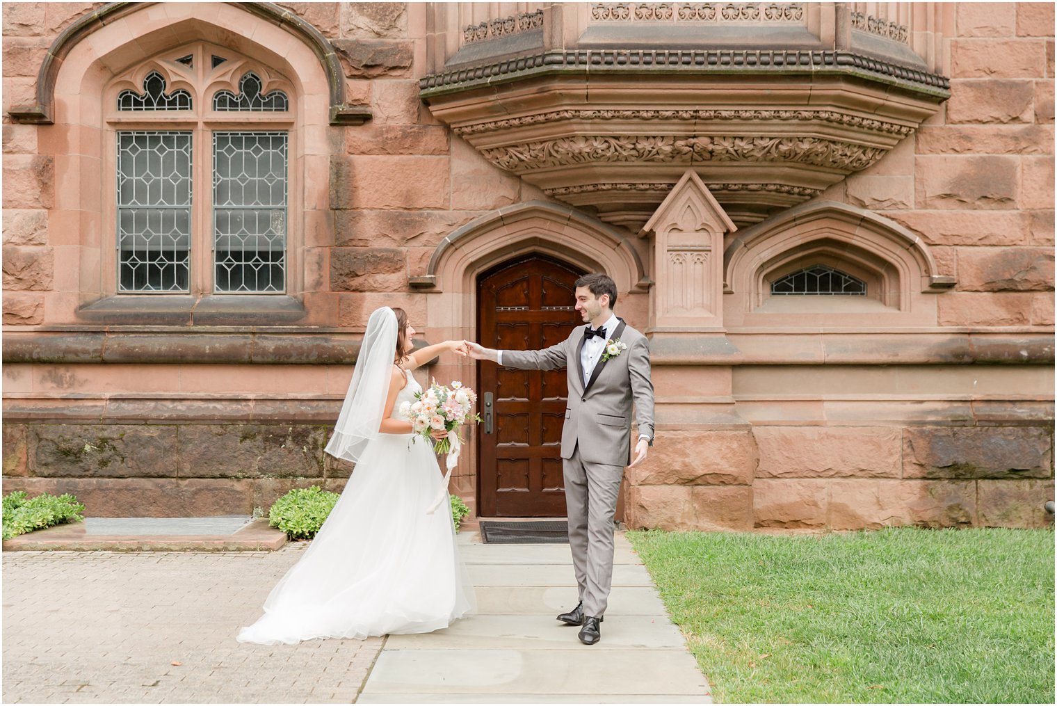 groom twirls bride outside Princeton University