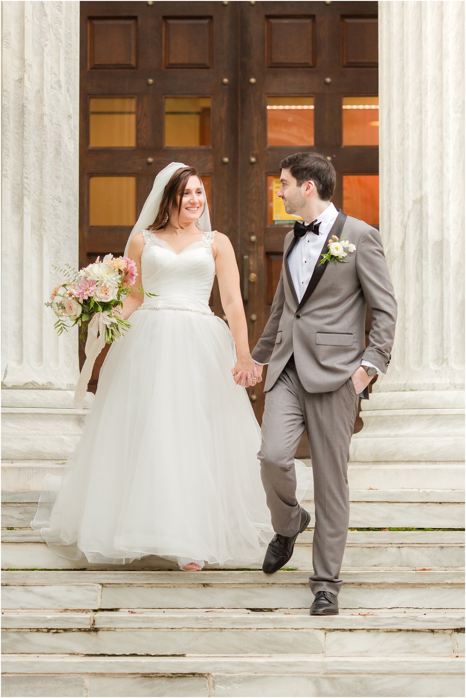newlyweds walk down steps at Princeton University