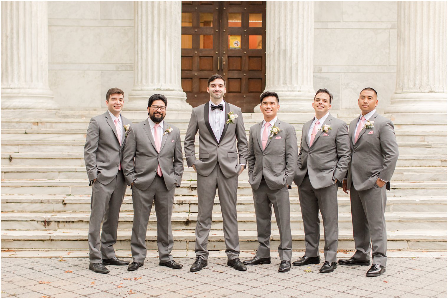 groom stands with five groomsmen in grey suits at Princeton University